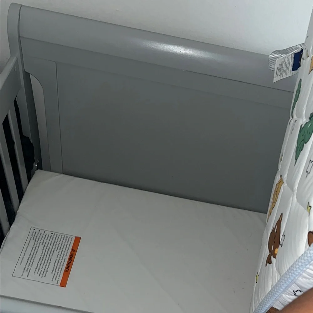 Gray Baby Crib with Printed Mattress